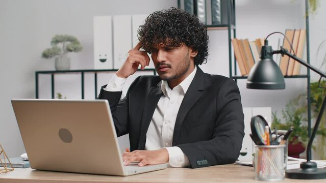 I dont know what to say. Confused business man working on laptop at office workplace. Freelancer feeling embarrassed about ambiguous question, having doubts, no answer idea, being clueless, uncertain