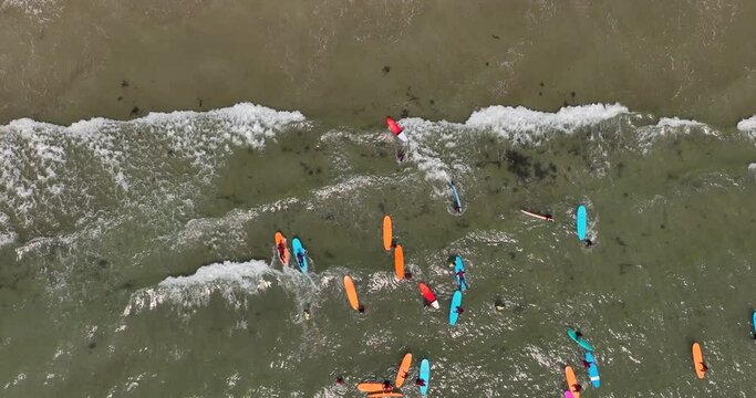 Top view of the beach with surfers waiting for a wave 4k