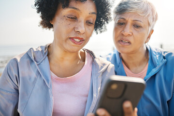 Phone, confused and senior friends on the beach together, browsing social media or reading a text message. Communication, summer and elderly women on the coast with a mobile to search for information