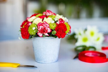 Beautiful arrangement of cut flowers in a vase on a table in the flower shop
