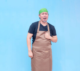 A talented middle-aged barista singing earnestly with fist on his chest. Isolated on a blue...