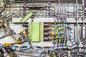 Detailed image of various pipes, hoses, tubes from the inside of an airplane. Hydraulic lines,...