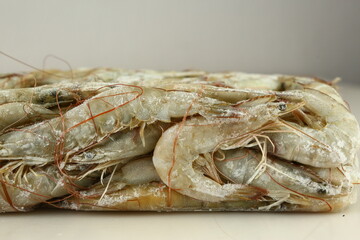 frosted white langoustine close up photo on white table background