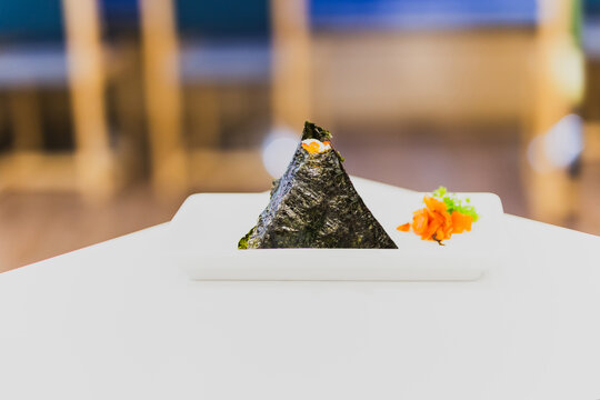 Japanese Onigiri traditional food in triangle shape wrap with seaweed.