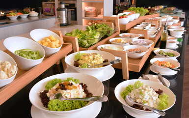 healthy salad corner with assorted vegetables cucumber, carrot, tomato, green leaf, sauce luxury hotel breakfast lunch dinner buffet table halal food menu for restaurant