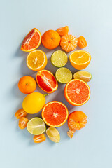 Mixed fruits background layout - many citrus slices top view.