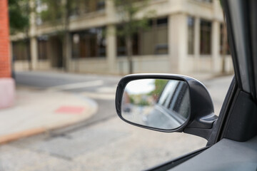 Car mirror reflects life's journeys, offering introspection and foresight. Symbolizes reflection, self-awareness and moving forward