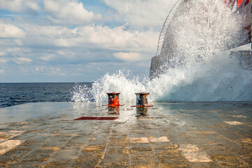 The surf splashes against the St Elmo Breakwater and the spray whips up to the St Elmo Bridge