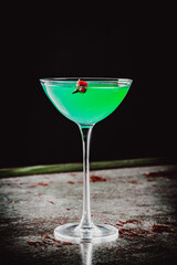 alcohol cocktail in a glass stands on a table in a bar or restaurant