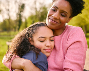 Loving Mature Mother With Teenage Daughter Enjoying Walk In Countryside Together