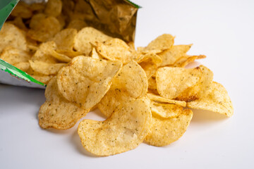 Potato chips, delicious spicy for crips, thin slice deep fried snack fast food in open bag.