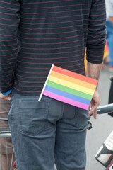 Gay pride spectator carrying rainbow gay flag during pride march