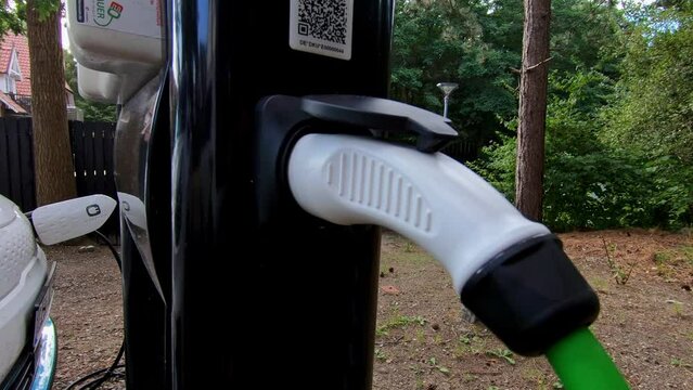 Electric car battery charging at charge station in the nature