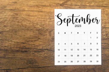 A September 2023 Monthly calendar for 2023 year on wooden background.