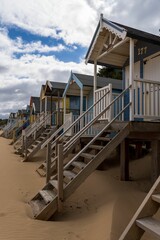 Vibrant beach scene featuring an assortment of beach huts in a variety of colors on the sand