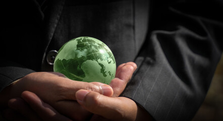 business hands warming the world environmental concept Coexistence of entrepreneurs and the environment.