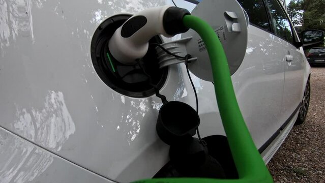 EV charging station for electric car in concept of green energy and eco power produced from sustainable source to supply to charger station in order to reduce CO2 emission .