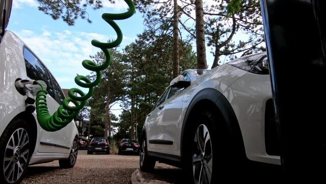 Electric car battery charging at charge station in the nature
