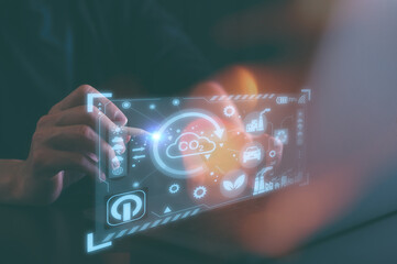 Hand touching CO2 reducing icon in concept of decrease carbon dioxide emission ,carbon footprint...