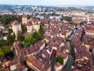 Romantic beautiful old town of Annecy aerial drone view with medieval castle.