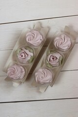 Homemade marshmallows in paper gift boxes. Zephyr flowers. The box is open.