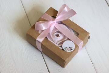 Homemade marshmallows in a paper gift box. Zephyr flowers. The box is tied with a ribbon tied into...