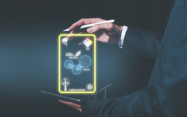 businessman using digital tablet working with sign CO2 reducing icon in concept of decrease carbon...