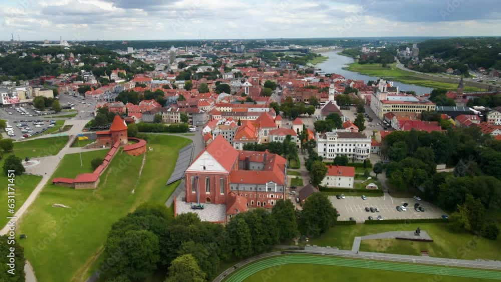 Poster Drone shot over Kaunas Castle with a town view and red houses