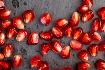 Peeled red pomegranate with ripe grains