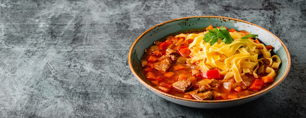 Lagman soup with lamb, homemade noodles and vegetables.