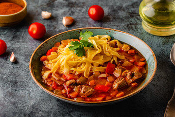 Lagman soup with lamb, homemade noodles and vegetables.