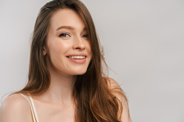Fototapeta premium Close up portrait of beautiful smiling woman with toothy smile looking at camera