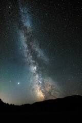 Fototapeta na wymiar Stunning milky way night sky illuminated by stars above mountains in BC, Canada