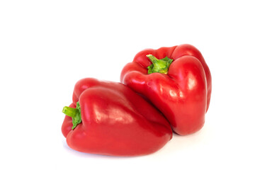 2 red peppers from different sides on a white background, large, close-up.