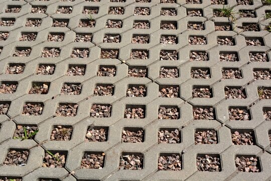 Concrete openwork plates used as garden road and parking lot for cars