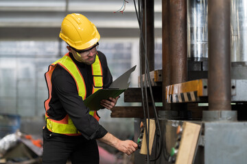 Male electrician worker checking, repair, maintenance electric system of CNC machine in factory. Male electrician engineer inspecting quality electric during manufacturing process