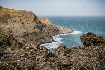 Fototapeta na wymiar Aerial view of a dramatic rocky cliff overlooking the vast expanse of the ocean