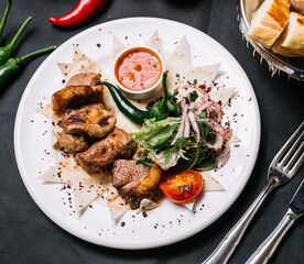 lamb kebab on lavash onion greens tomato lettuce pepper top view