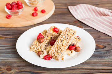 Various granola bars on table background. Cereal granola bars. Superfood breakfast bars with oats, nuts and berries, close up. Superfood concept