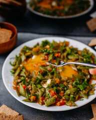 a front view sliced vegetable meal fried colorful vegetables meal along wtih bread loafs eggs inside white plate on the grey background