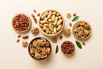 Walnut kernel halves, in a wooden bowl. Close-up, from above on colored background. Healthy eating Walnut concept. Super foods with copy space