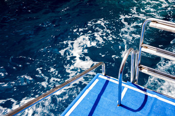 Tour boat with stairs going in blue  sea