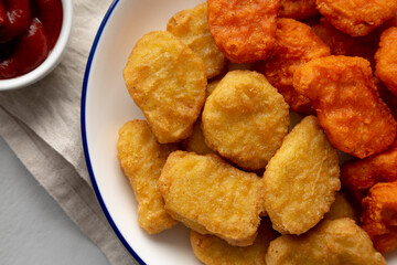 Homemade Spicy Chicken Nuggets Mix on a Plate, top view. Close-up.