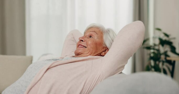 Smile, relax and senior woman stretching on sofa in home living room for peace. Happy, calm and elderly person with relief, freedom and no stress, breathing and comfort on couch in lounge in house.