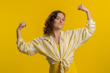 I am strong and independent. Young woman showing biceps and looking confident, feeling power...