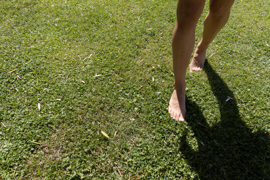 bare feet trampling a green meadow