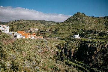 Fototapeta premium Mountainside town in the mountains with houses and a hill