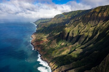 Aerial view of green mountains against the sea in Waimea Canyon State Park in Kauai County, Hawaii