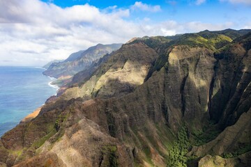 Aerial view of green mountains against the sea in Waimea Canyon State Park in Kauai County, Hawaii