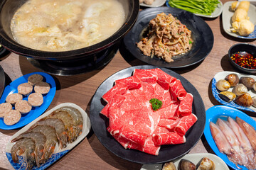 Hotpot with fresh slice of meat and food in restaurant